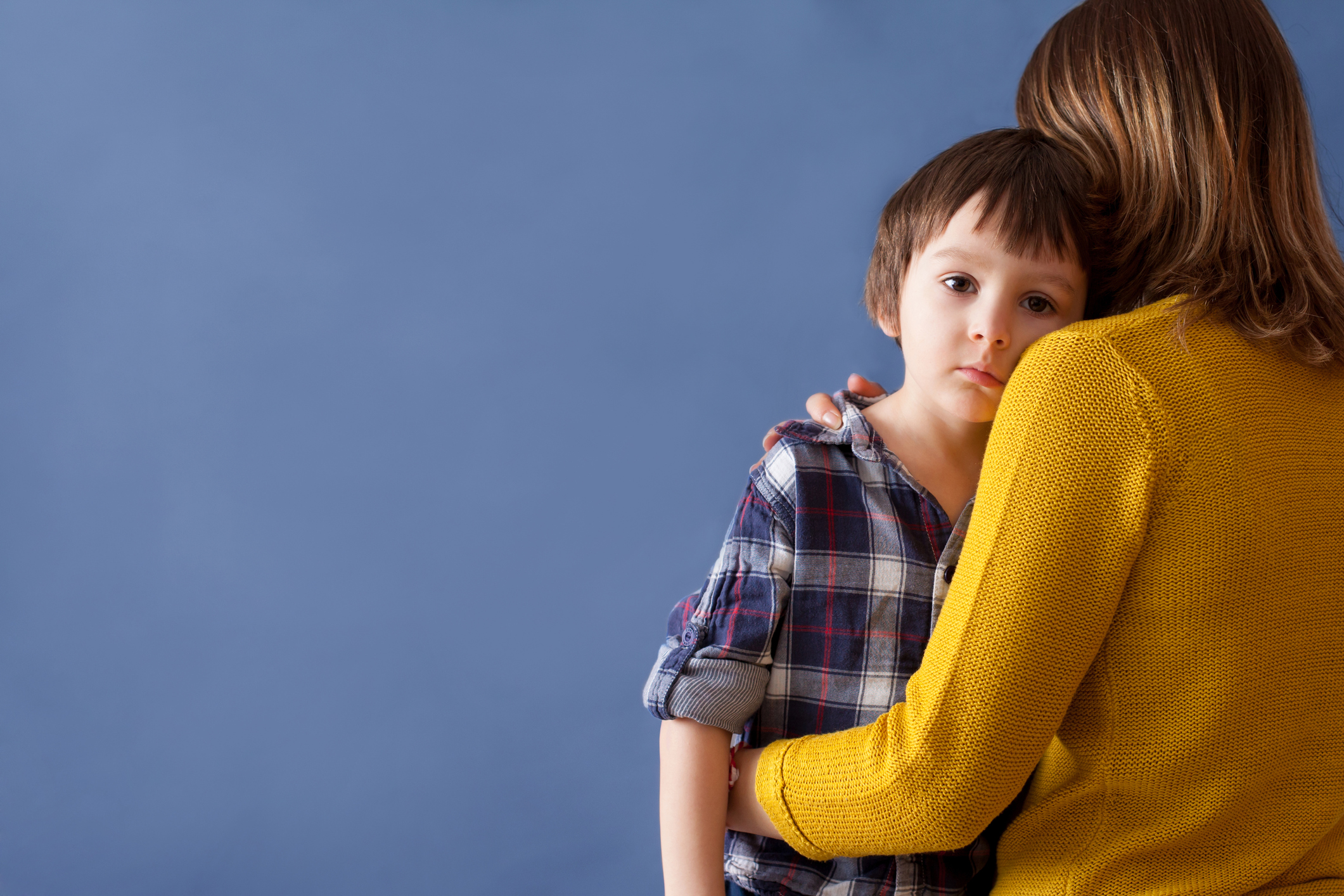 Sad little child, boy, hugging his mother at home Sad little child, boy, hugging his mother at home